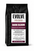 A 12 oz bag of Evolve Bean Coffee Company Dark Bloom Chocolate Raspberry coffee, in a matte black bag with a white and dark purple label.